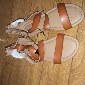 Brand new sandals, criss-cross straps over arch. Zipper in rear of shoe. Size 13